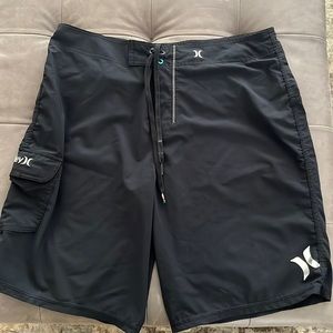 Mens Hurley size 36 black board shorts with silver / white logos. Front pocket.